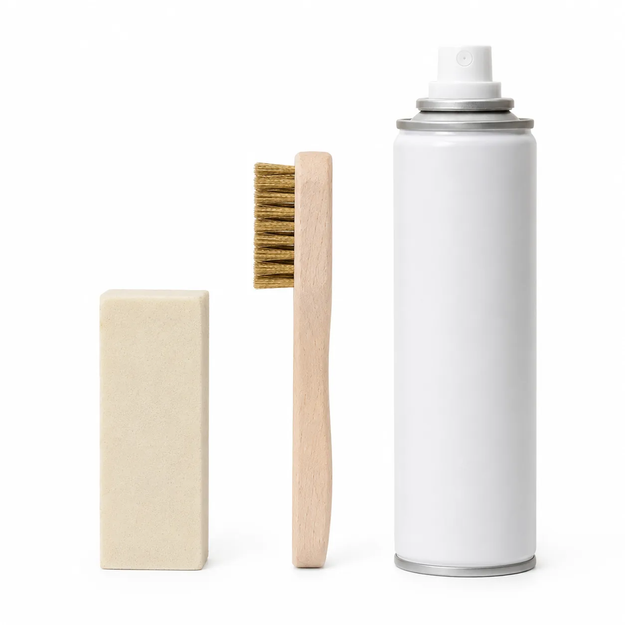Crepe eraser block, brass-bristle brush and protector spray can in a row